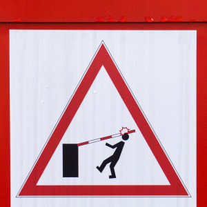 Warning sign man being hit by car park barrier