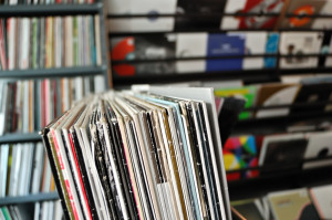 Vinyl music audio records with colorful sleeves at record store. Selective focus.