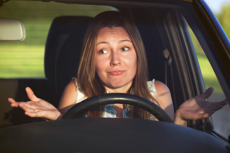 woman in car looking confused about safe parking